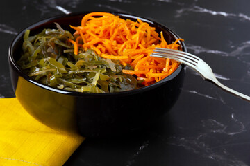 Sea kale Laminaria in black bowl.