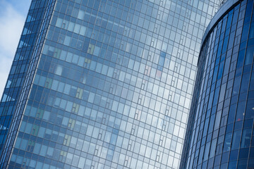 Fototapeta na wymiar Steel light blue background of glass high rise building skyscraper commercial modern city of future.
