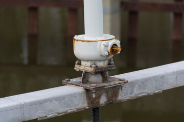 Mechanical valve on a pond water dam.