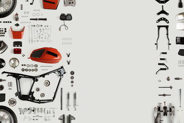 Top view of disassembled motorcycle on a light background with copy space