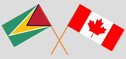 Crossed flags of Guyana and Canada. Official colors. Correct proportion