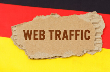 Against the background of the German flag lies cardboard with the inscription - Web Traffic