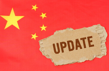 Against the background of the Chinese flag lies cardboard with the inscription - update
