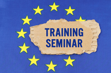 There is a cardboard box on the EU flag that says- TRAINING SEMINAR