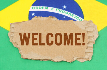 Against the background of the flag of Brazil lies cardboard with the inscription - Welcome