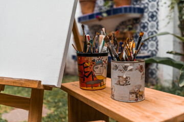 Paint brushes and painter's tools on a wooden bench