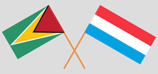 Crossed flags of Guyana and Luxembourg. Official colors. Correct proportion