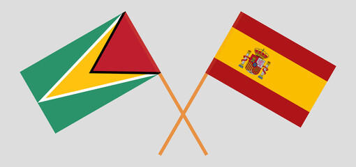 Crossed flags of Guyana and Spain. Official colors. Correct proportion