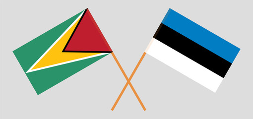 Crossed flags of Guyana and Estonia. Official colors. Correct proportion