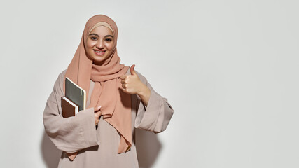 Cheerful young arabian woman student in hijab