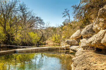 Jacob"s well is a perennial karstic spring in the Texas Hill country