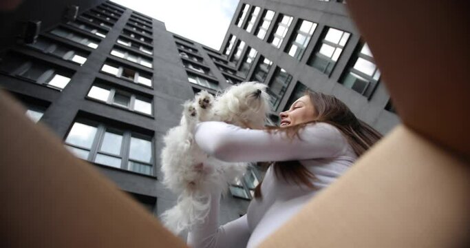 Happy woman and man couple open delivery internet shopping box, smiling woman looking inside e-commerce clothes cat dog pet in delivery box, wow effect coronavirus quarantine isolation