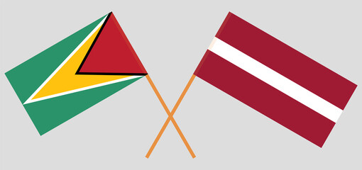 Crossed flags of Guyana and Latvia. Official colors. Correct proportion