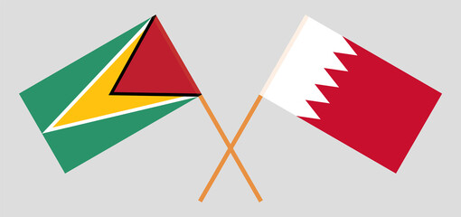 Crossed flags of Guyana and Bahrain. Official colors. Correct proportion