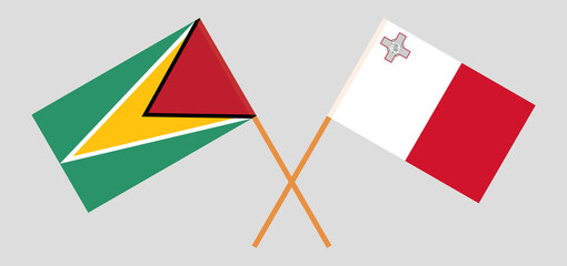 Crossed flags of Guyana and Malta. Official colors. Correct proportion