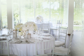 White styled table decoration of the wedding event