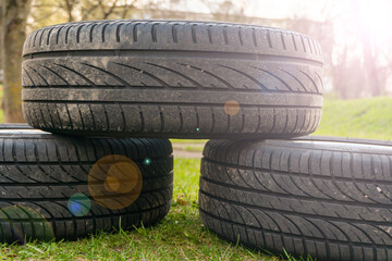 Winter tires close up with flare effect. Self replacement of winter tires on a car with summer wheels. Swap winter wheel for summer tire.