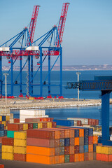 berthing container heavy cranes for loading multi-colored containers to the berth of the seaport in the customs dock for the passage of brokerage expertise of the goods, nobody.