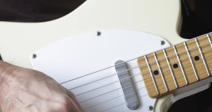 Musician plays tele - type electric guitar, close-up, real people