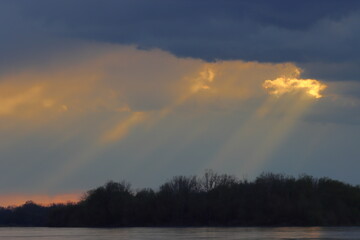 sunlight breaking through the clouds, sunset in the clouds