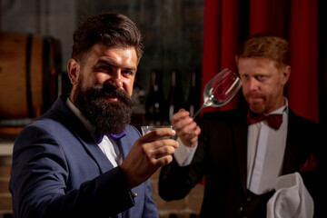 Barman at counter. Bartender working and takecare customer. Wine for customer. Alcohol serving.