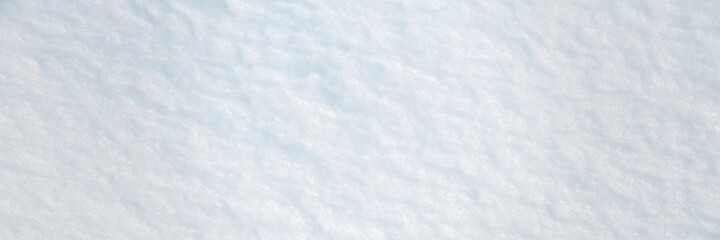 Natural snow texture. Smooth surface of clean fresh snow. Snowy ground. Winter background with snow patterns. Perfect for Christmas and New Year design. Closeup top view.