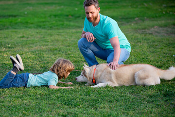 Child with pet friend. Father and son with dog spending time outdoor.