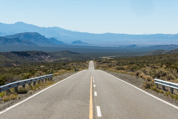 Straight, empty road or route in an arid place