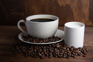 Coffe cup with milk and coffee grains