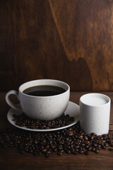 Coffe cup with milk and coffee grains