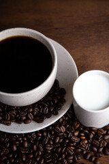 Coffe cup with milk and coffee grains