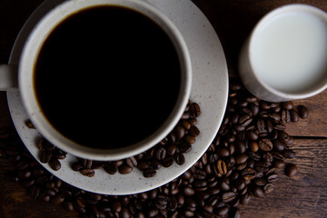 Coffe cup with milk and coffee grains