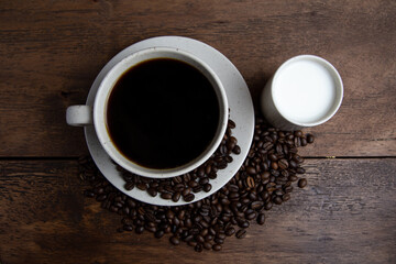 Coffe cup with milk and coffee grains
