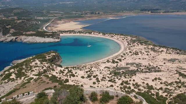 Aerial panorama view of the famous semicircular sandy beach and lagoon of Voidokilia in Messenia, Greece