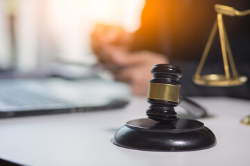 Business and lawyers discussing contract papers with brass scale on wooden desk in office. Law,...