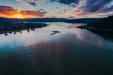 Aerial sunrise waterscape with boats and cloud cover