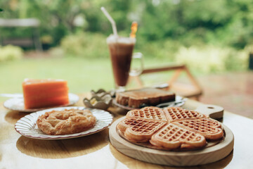 Fresh waffles on wood plate. Waffle and dessert concept.