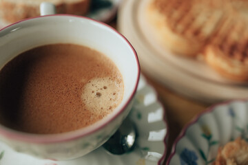 Hot coffee americano on the table. A cup of coffee in  plate.