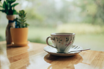 Hot coffee americano on the table. A cup of coffee in  plate.