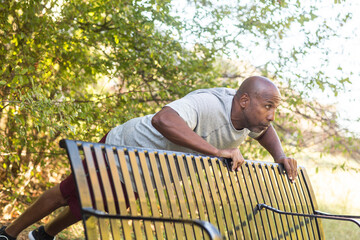 Mature African American working out and doing push ups.