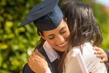 Mother hugging her daugher at her graduation