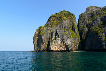Thai traditional long-tailed boats moored in front of the western part of Ao Maya, Koh Phi Phi Le, Krabi, Thailand.