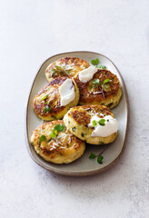 Cottage cheese fritters with spinach and parsley closeup