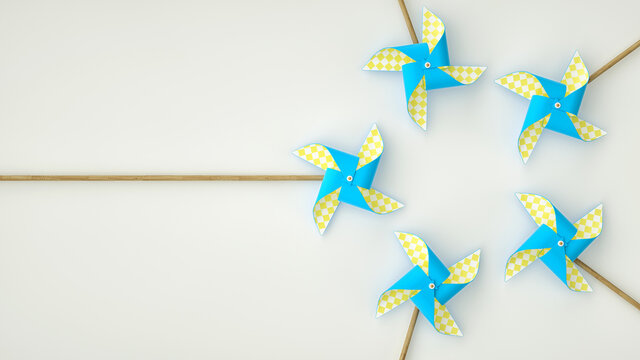 Blue yellow pinwheel on white background with copy space.
