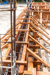 The wooden mold for concrete foundation of a house. The rebar steel for concrete slap and pole.