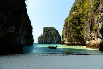 A Thai traditional long-tailed boat moored in front of Loh Samah Bay, Koh Phi Phi Le, Krabi,...