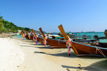 Many Thai long-tailed boats are in front of Ao Ton Sai Pier, Koh Phi Phi Don, Krabi, Thailand.