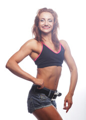 Photo of cheerful young woman dressed sportwear over white background.