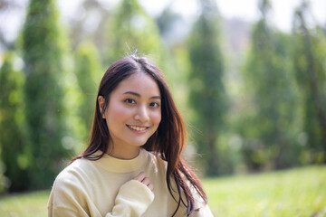 Fototapeta premium Beautiful Asian woman Smiling happy girl and wearing warm clothes winter and autumn portrait at outdoor in park