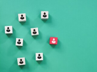 Successful team leader concept. Wooden cube block with people icon standing out from the crowd.
